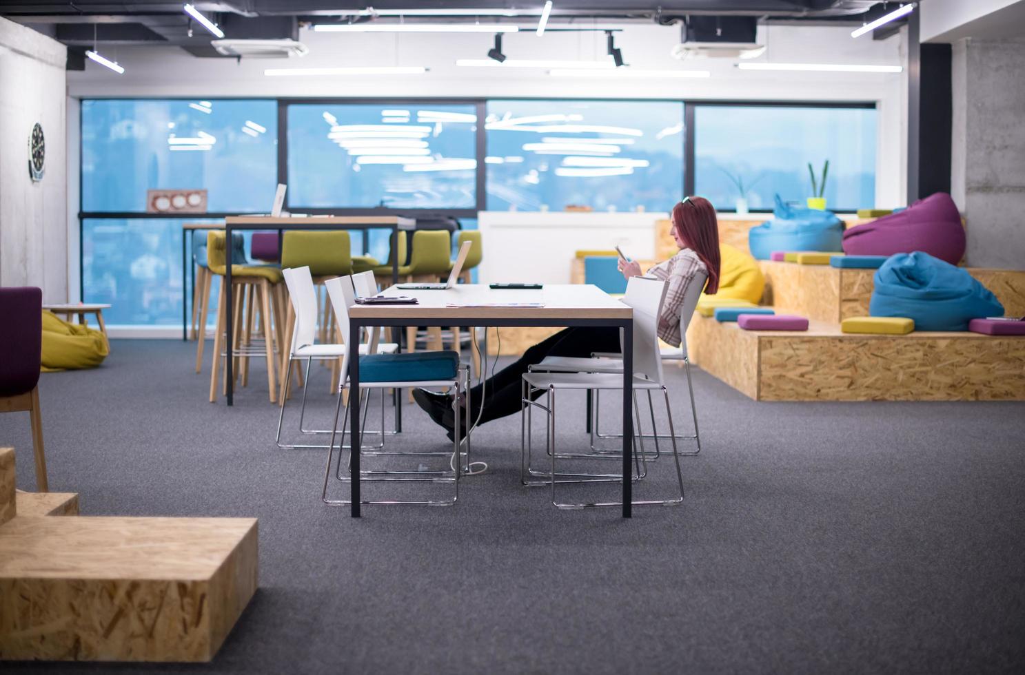 redhead businesswoman using mobile phone at office photo