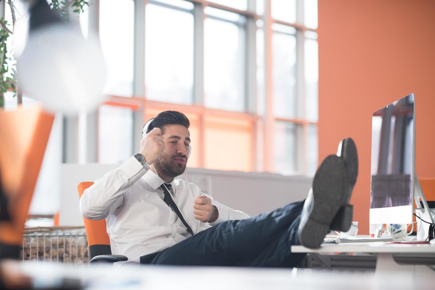 relaxed young business man at office photo