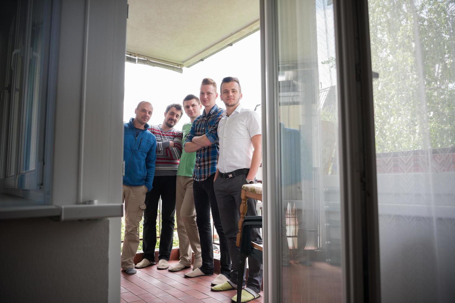 group of people standing at balcony photo