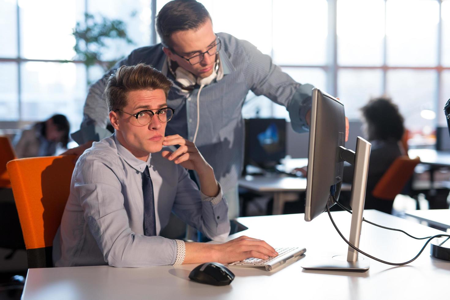 Two Business People Working With computer in office photo