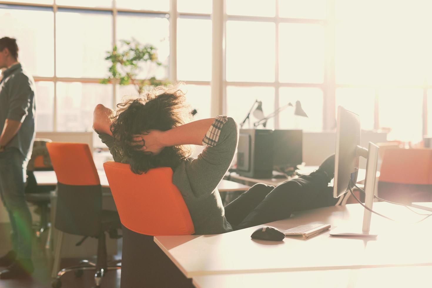 businessman sitting with legs on desk photo