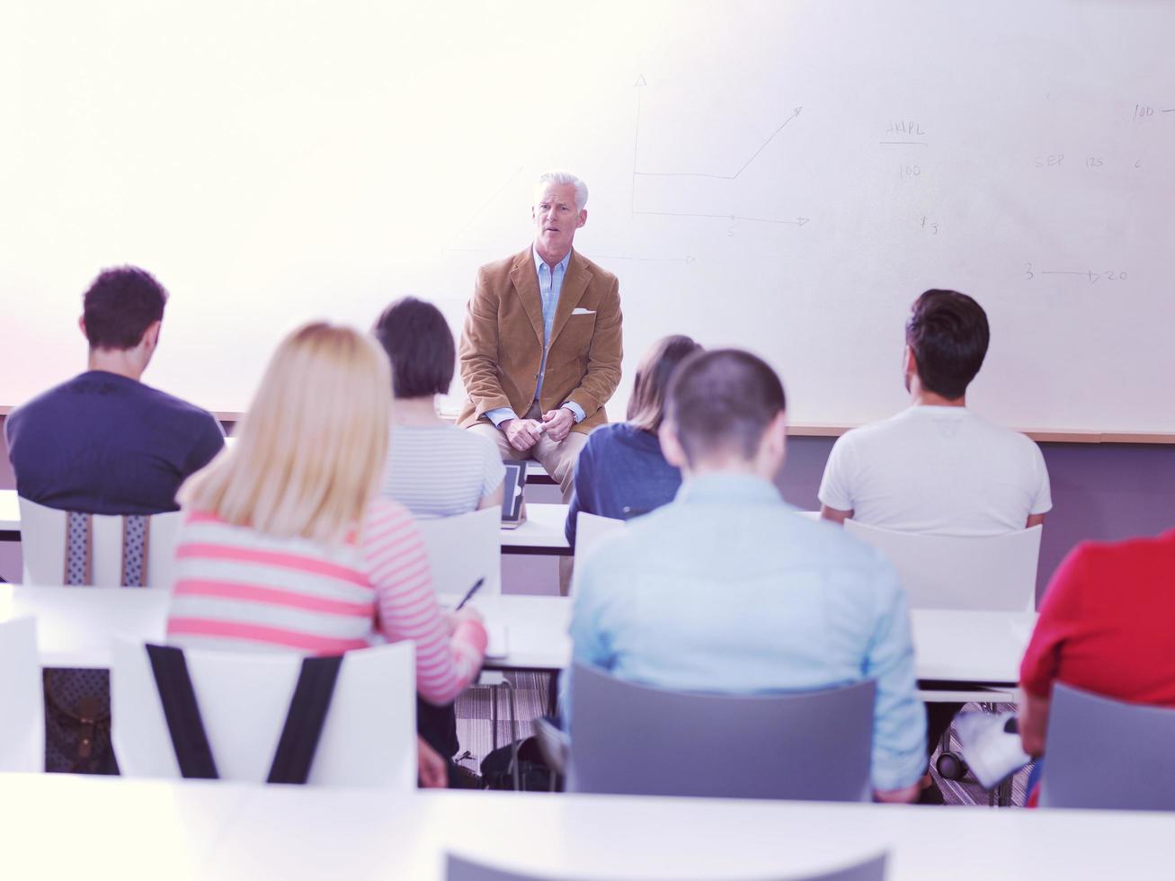 teacher with a group of students in classroom photo