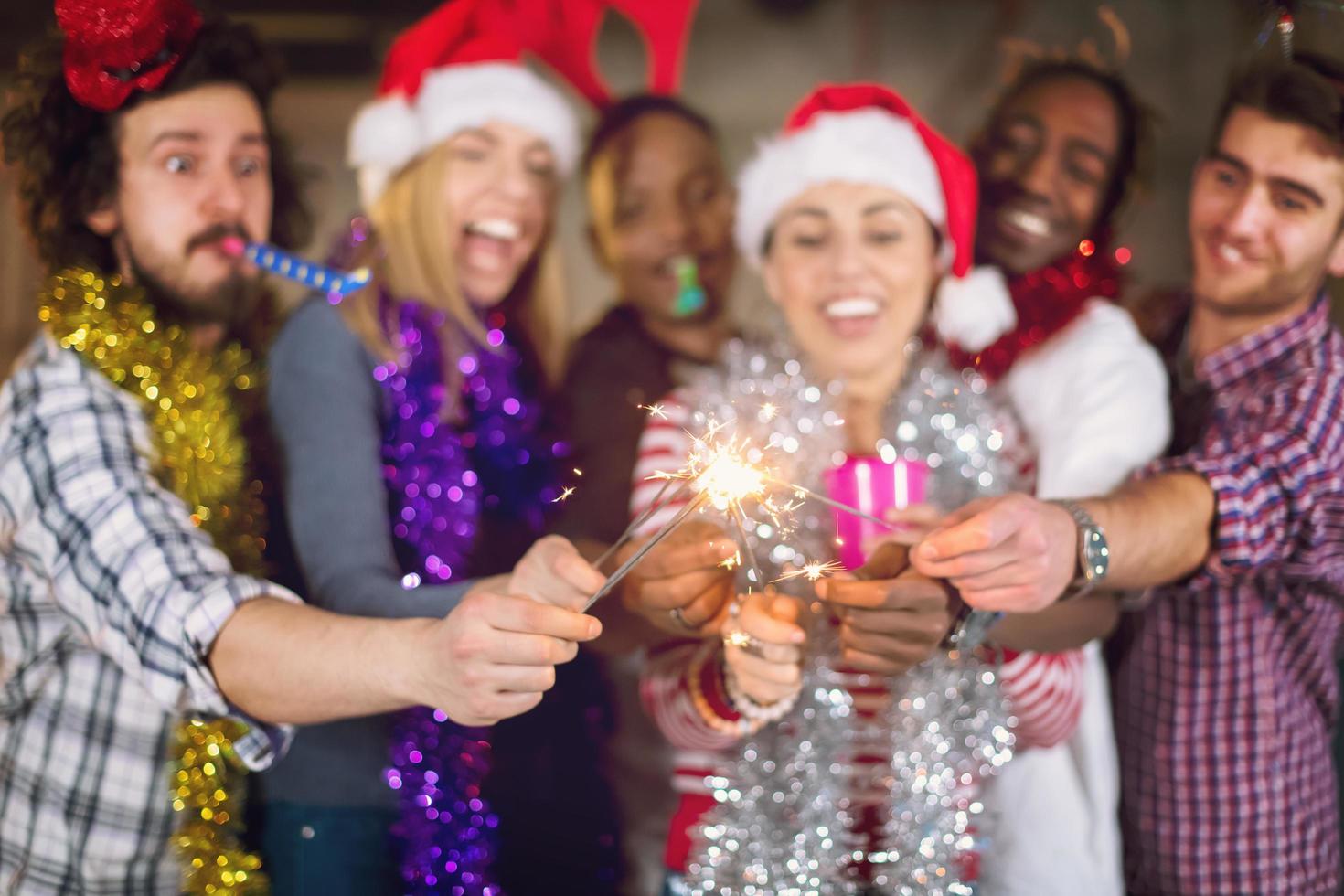 multiethnic group of casual business people lighting a sparkler photo