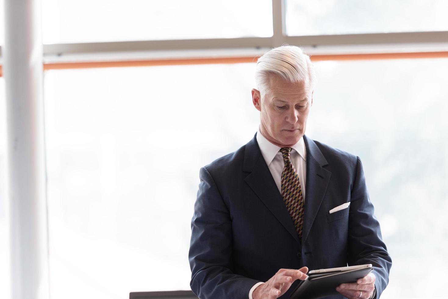 senior business man working on tablet computer photo
