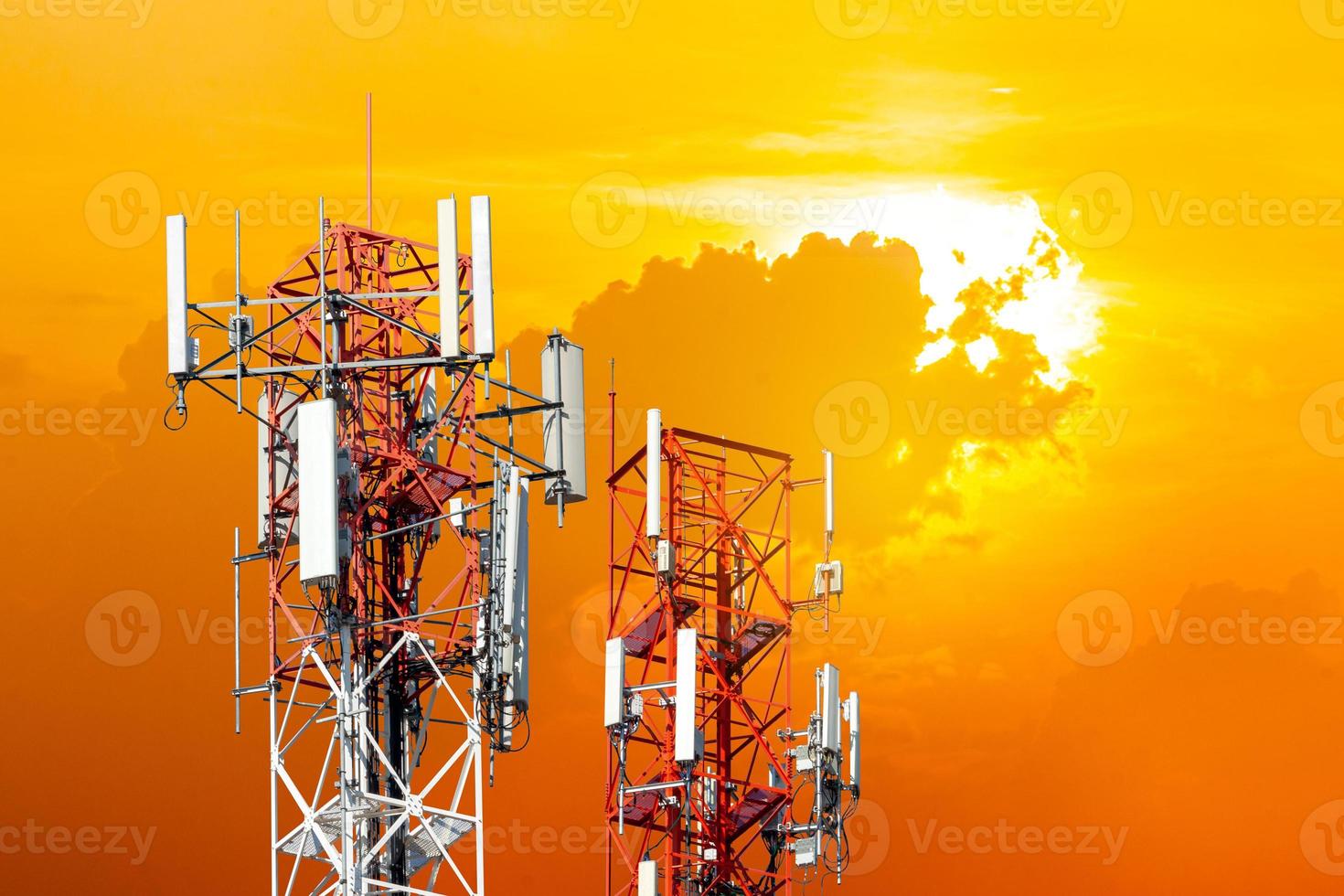 Telecommunication antennas tower in sunset background. photo