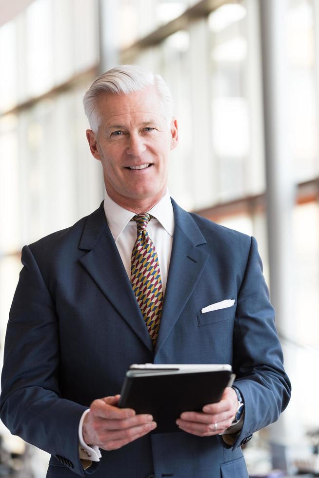 senior business man working on tablet computer photo