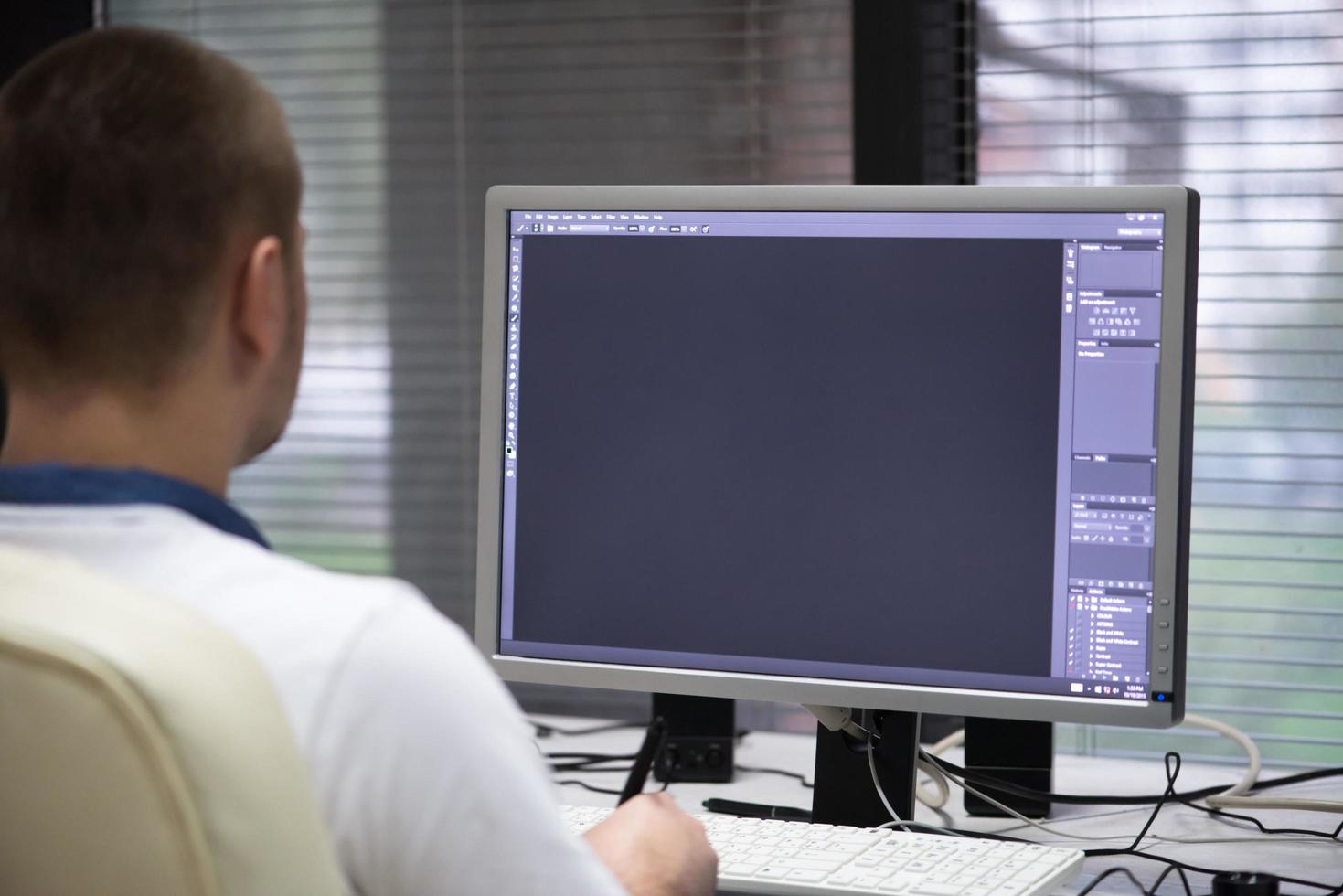 photo editor at his desk