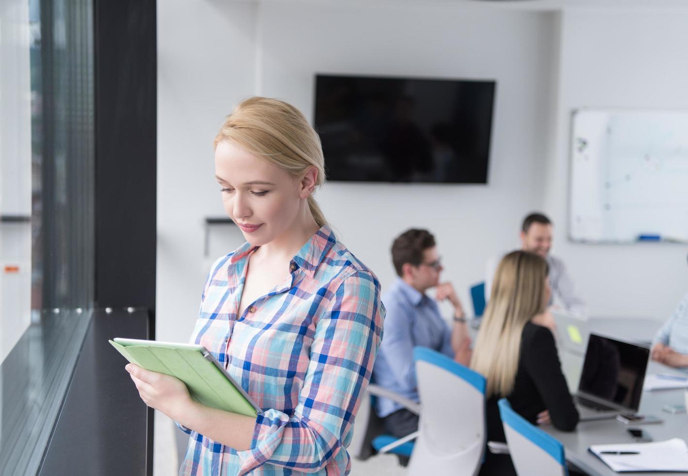 Pretty Businesswoman Using Tablet In Office Building by window photo