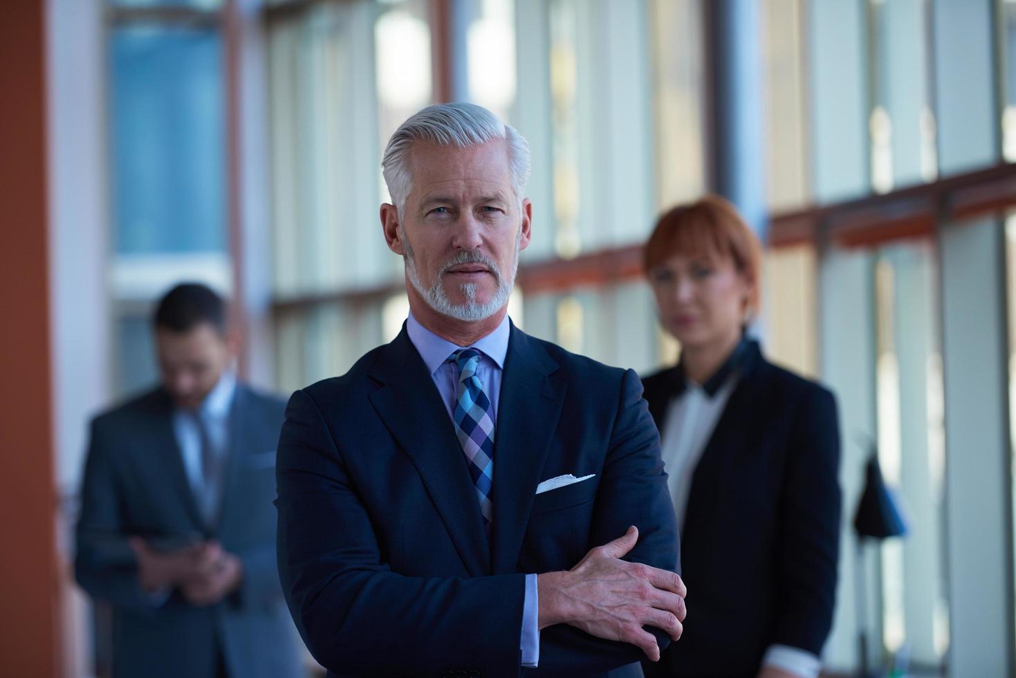 senior business man with his team at office photo