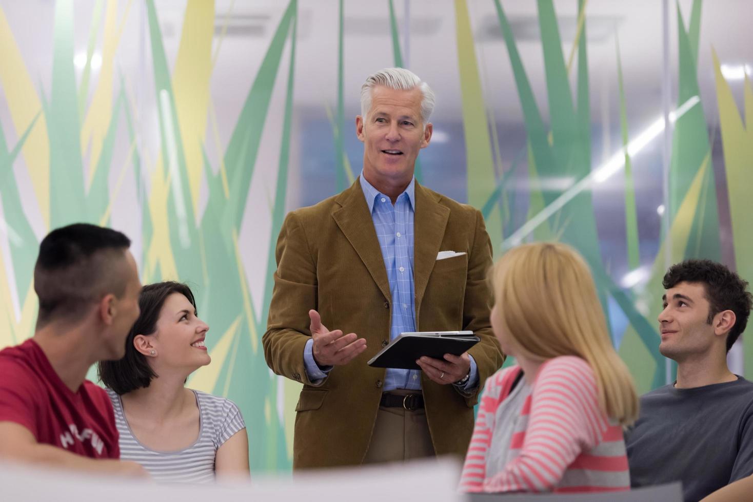 teacher with a group of students in classroom photo