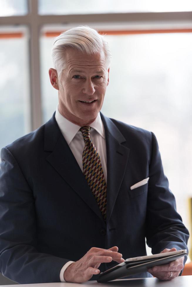 senior business man working on tablet computer photo
