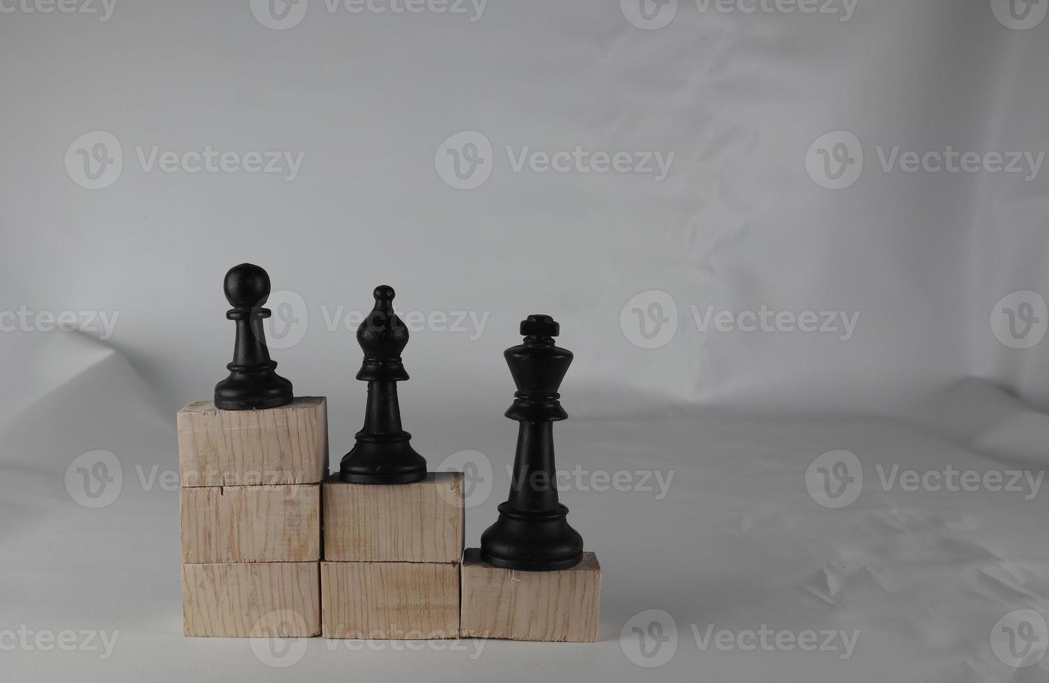 Chess pieces' from wooden cubes show the concepts of equity. Business concept photo