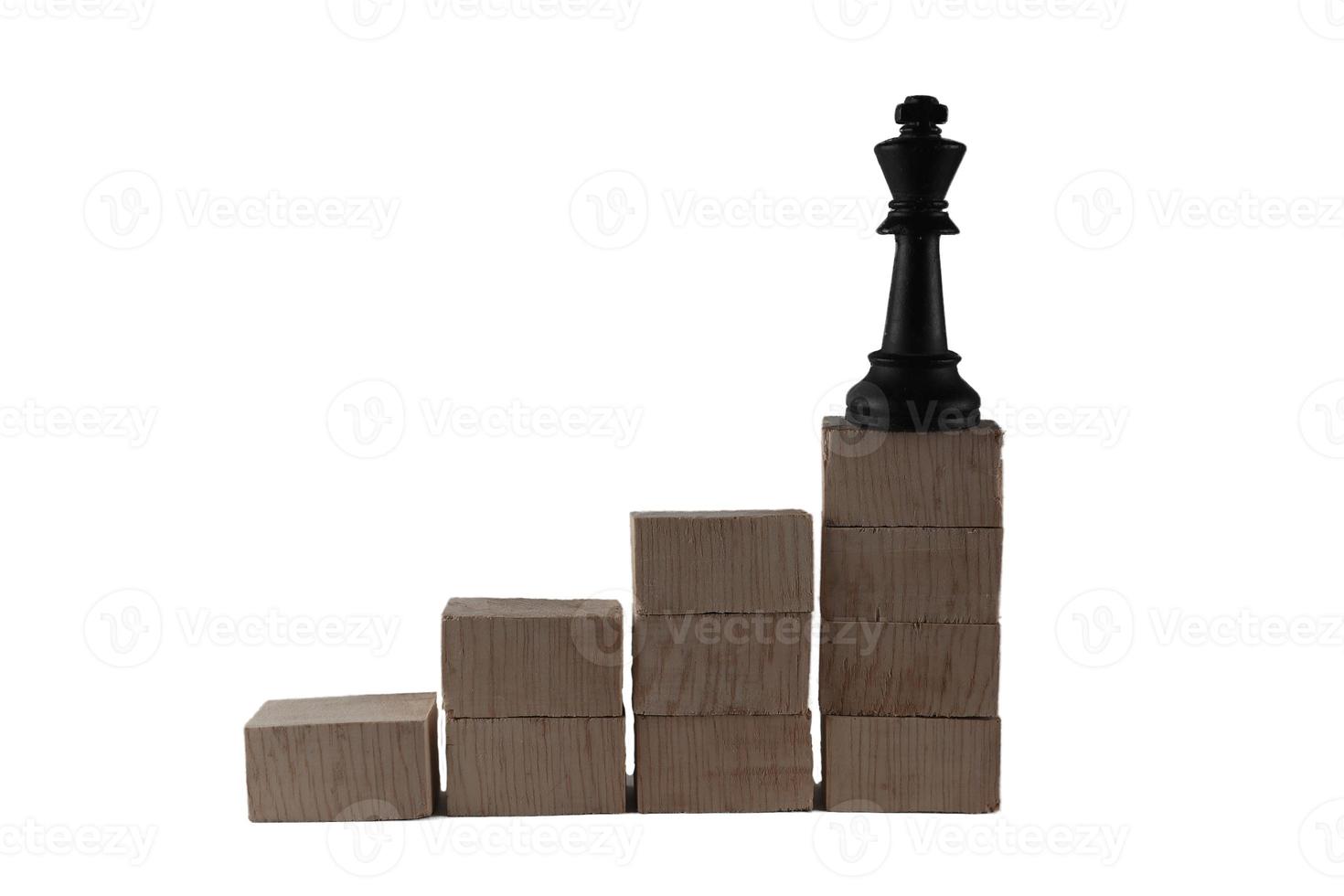 chess pieces on top of a wooden block. the concept of success of a leader photo