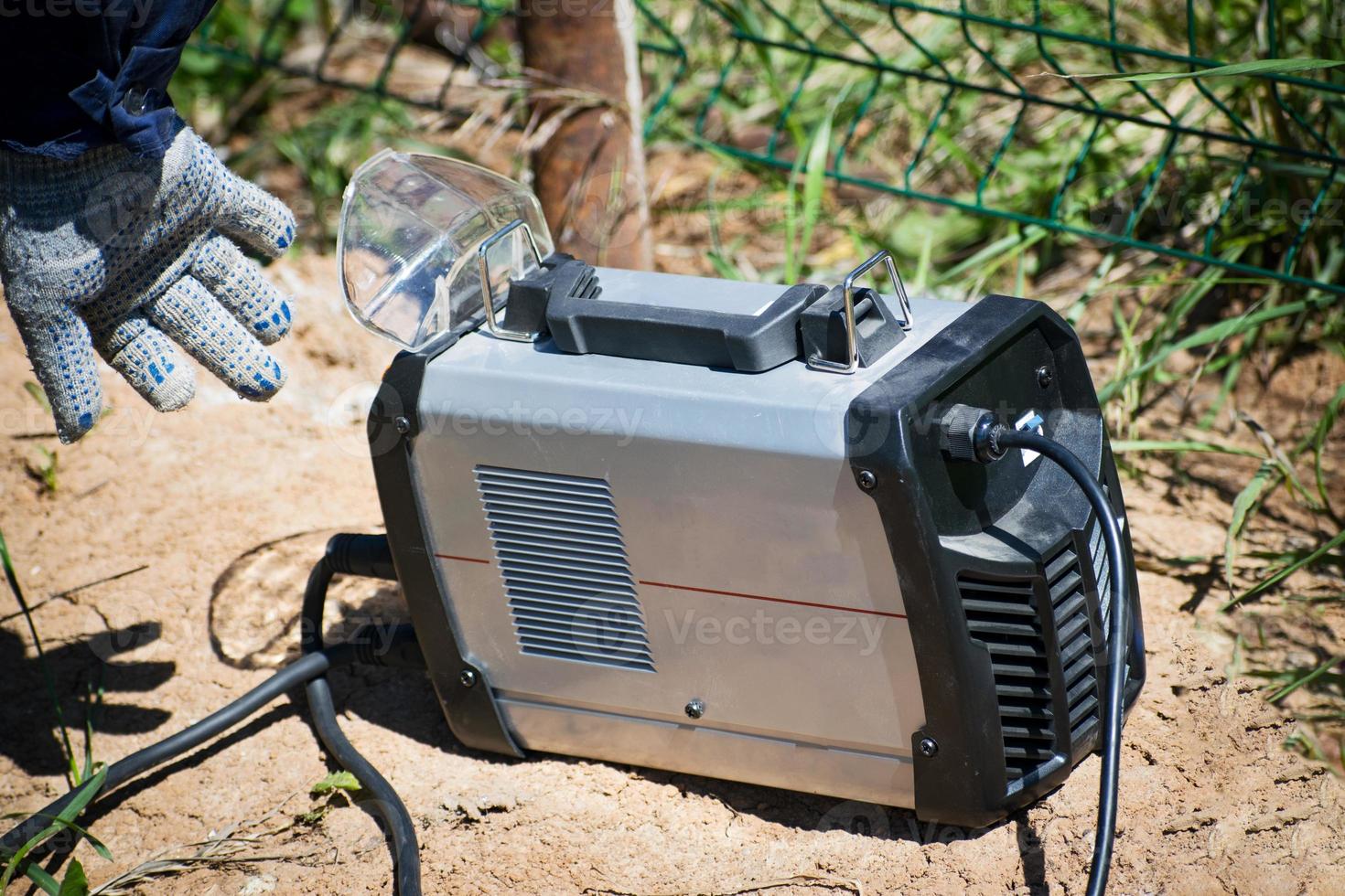 Inverter welding machine. Welding apparatus. Man turn on inverter welding machine or welding tool. photo