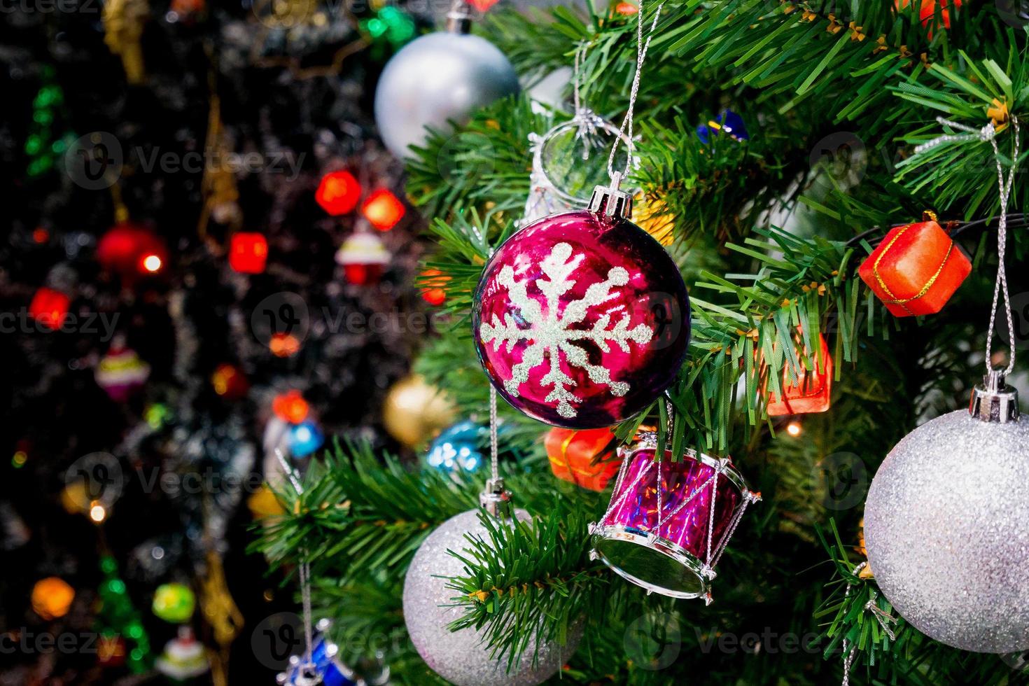 Decorated Christmas tree with colorful bauble on sparkling bokeh light blurred background photo