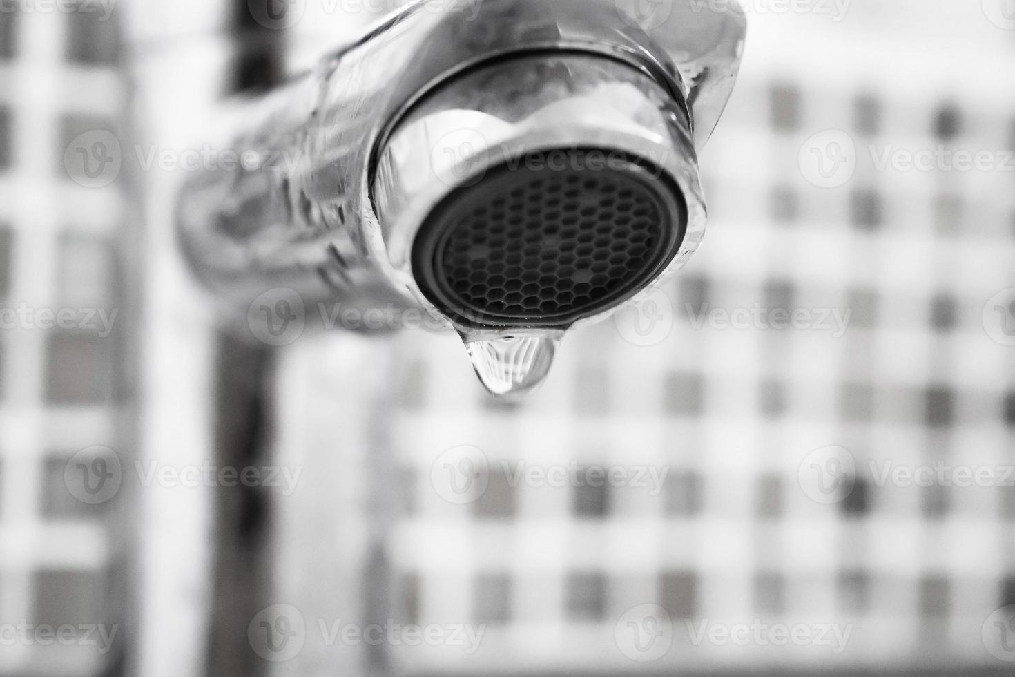 Close up faucet with water drop photo