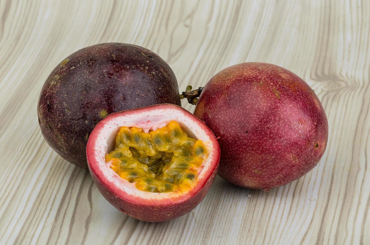 Passion fruit on wooden background photo