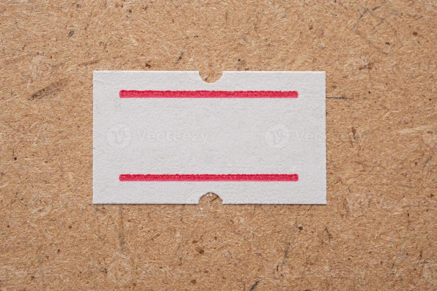 White paper sticker price on wooden background photo