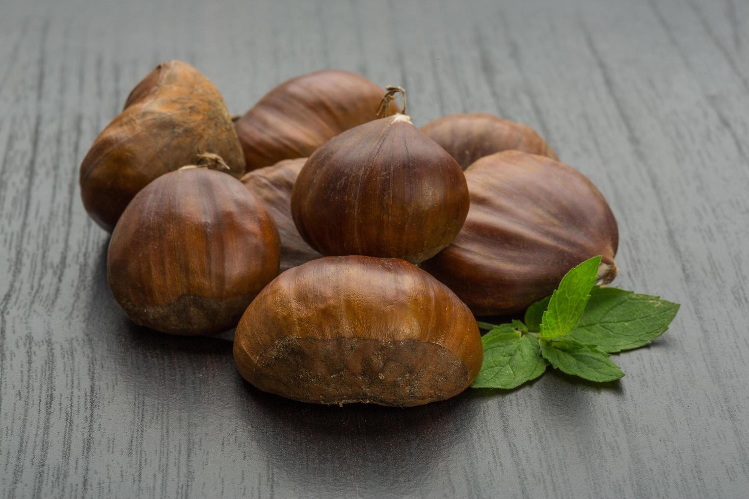 Chestnut on wooden background photo