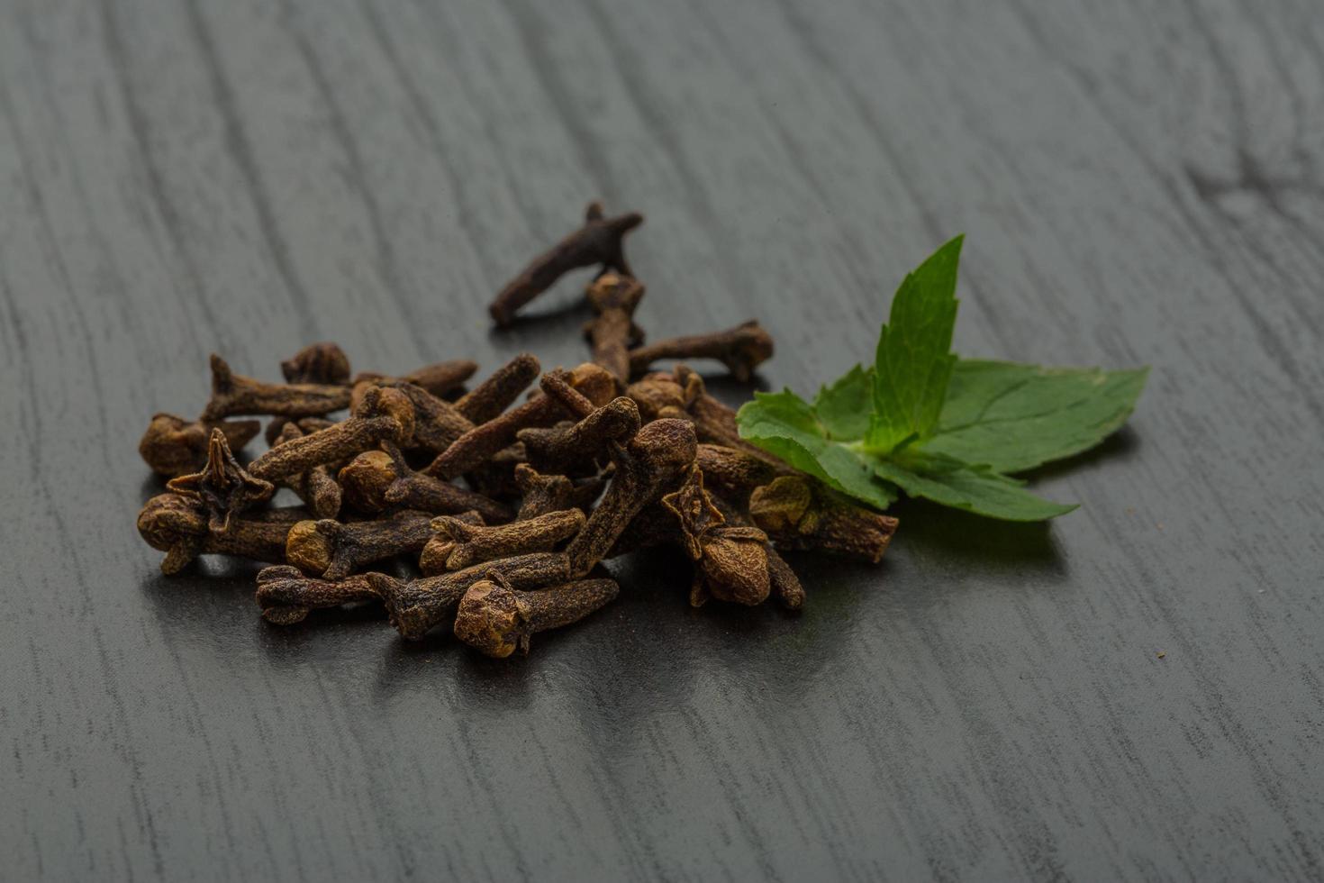 Clove seeds on wooden background photo