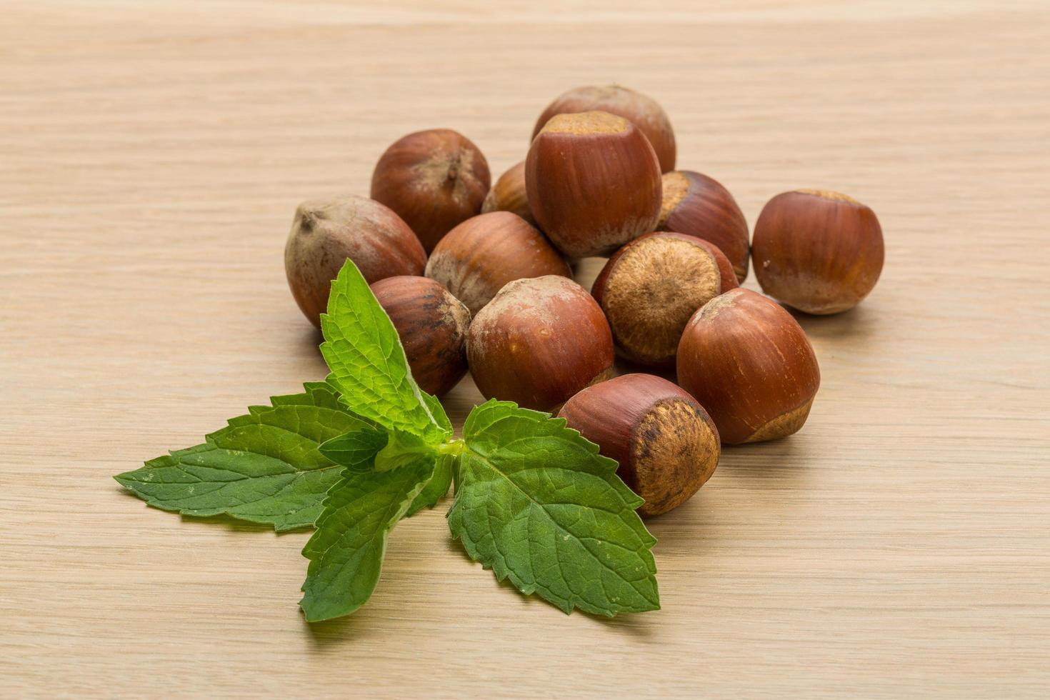 Hazelnut heap on wooden background photo