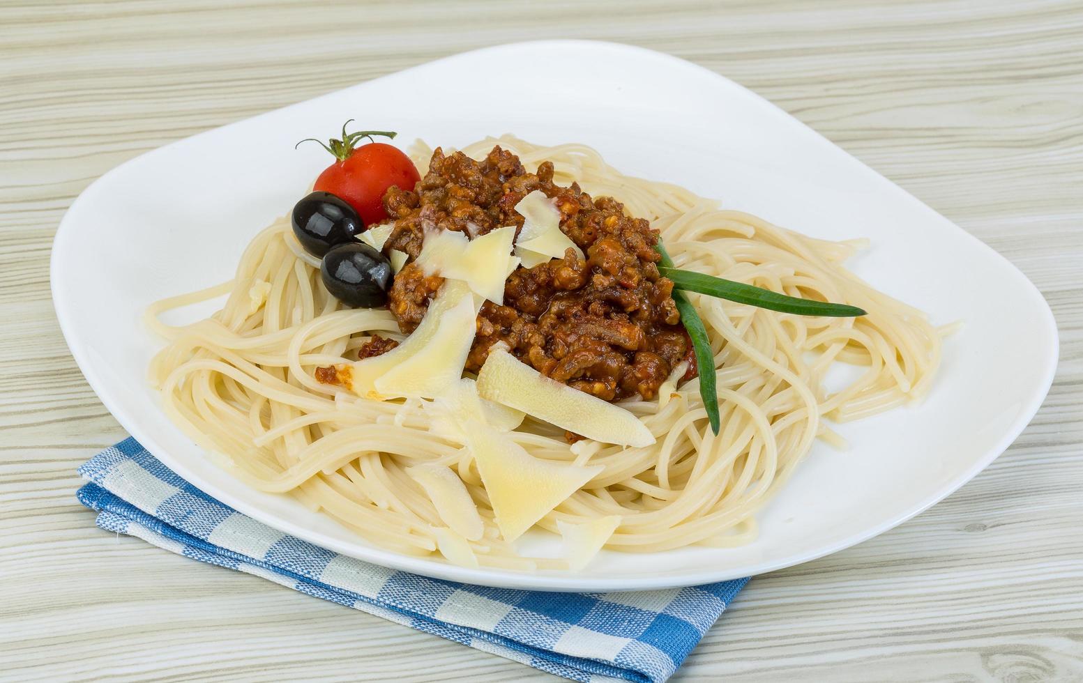 Spaghetti Bolognese on the plate and wooden background photo