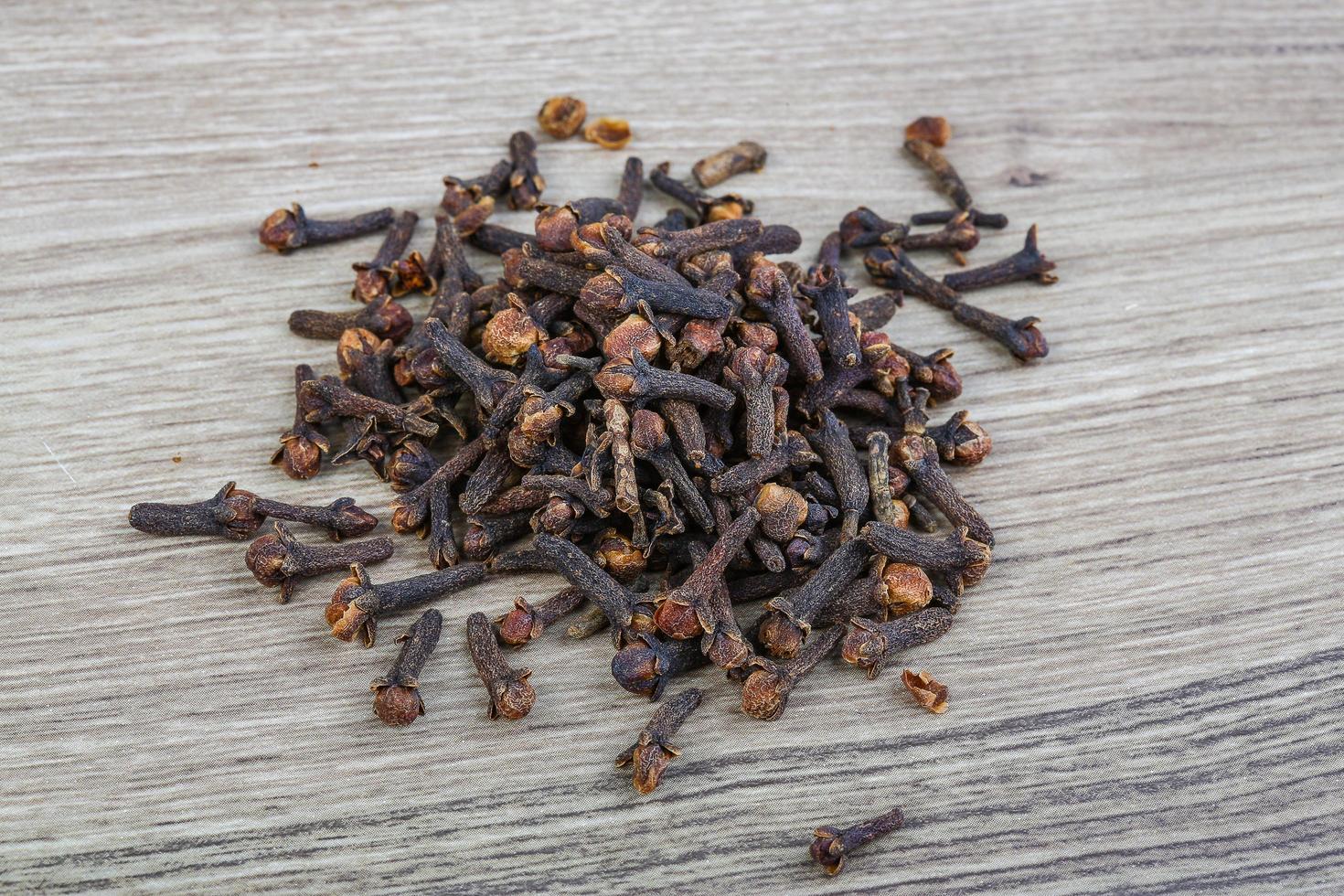 Cloves seeds on wooden background photo