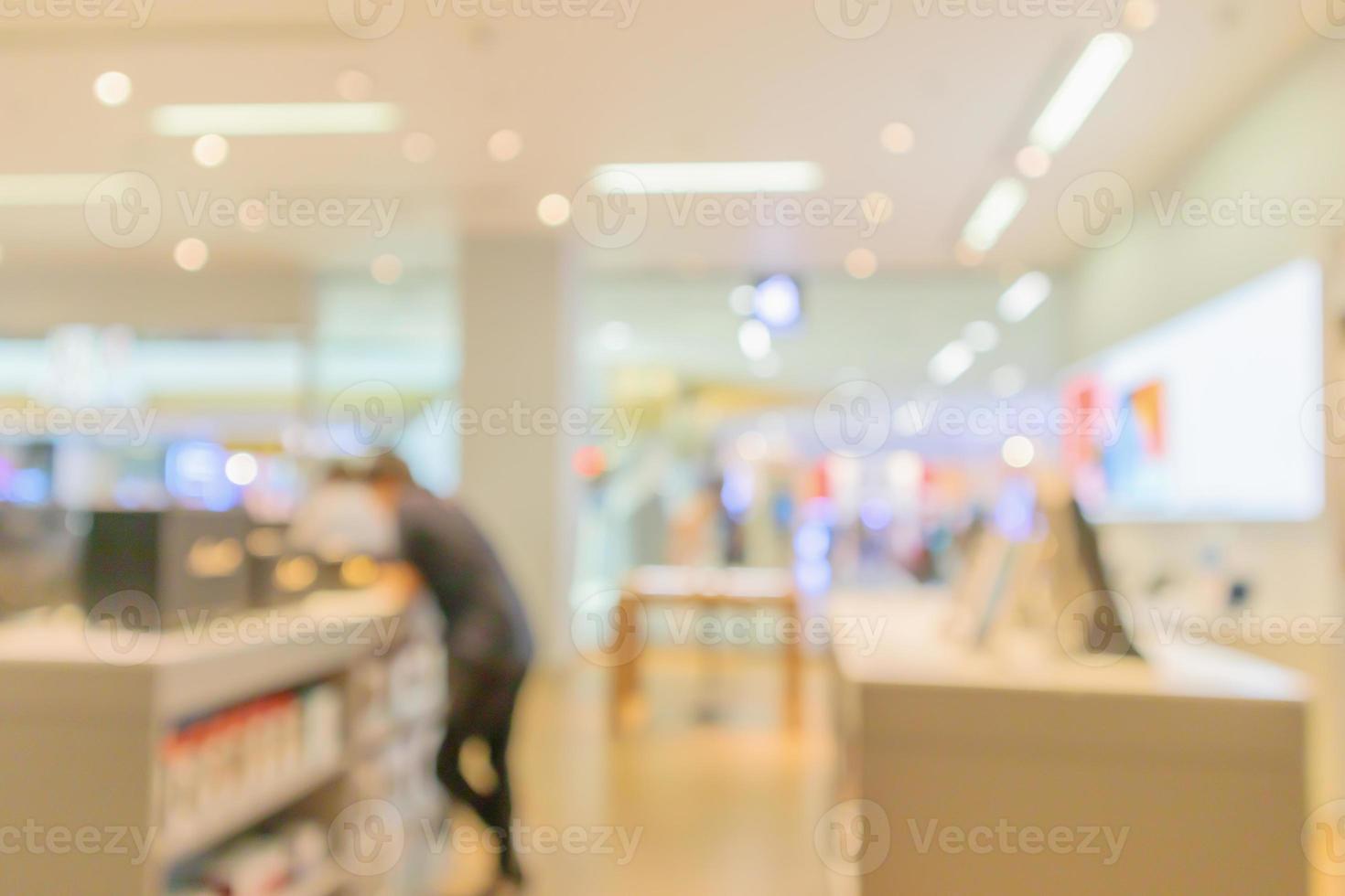 mobile phone in electronic store interior with customer abstract blurred background photo