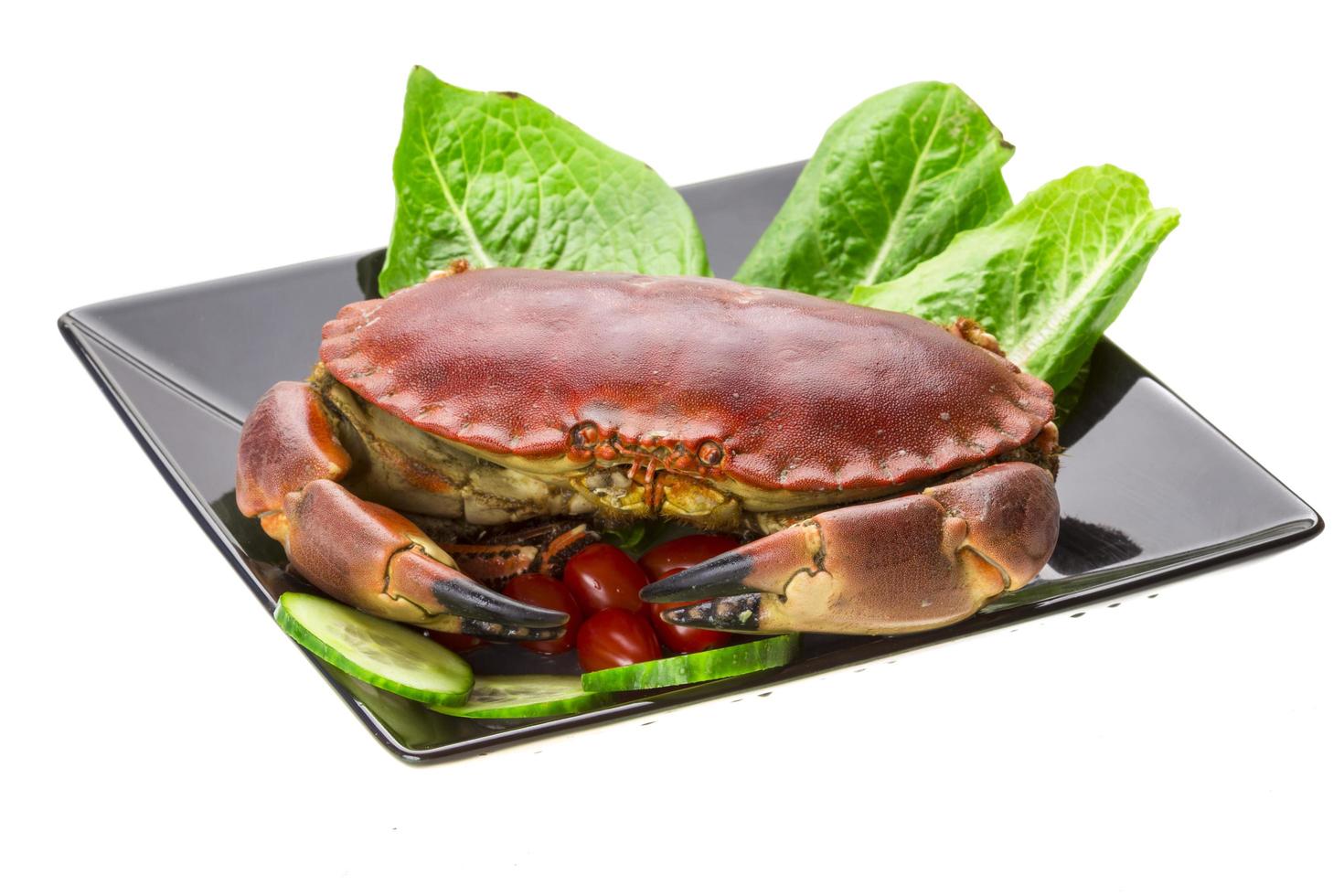 Raw crab on the plate and white background photo