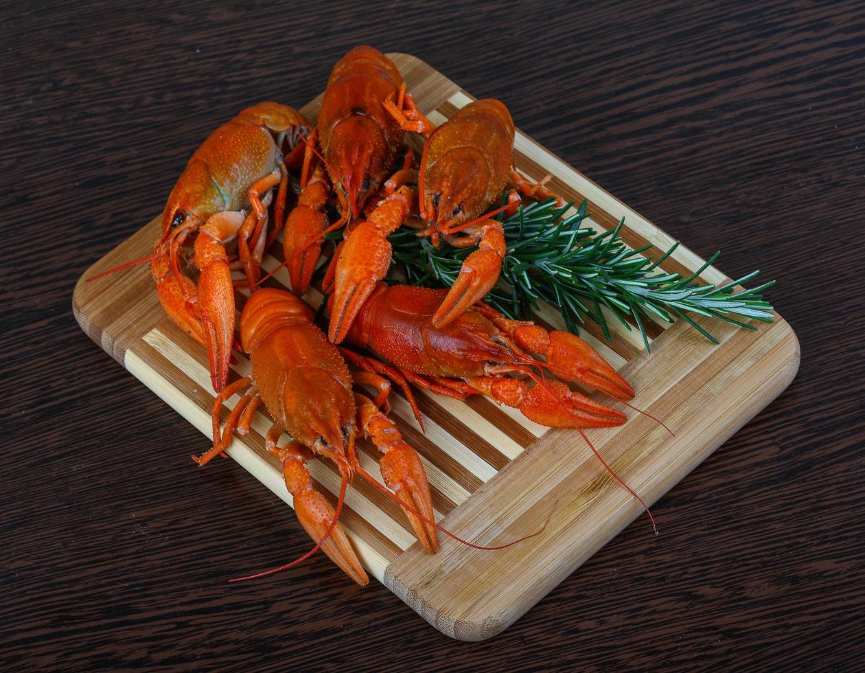 Crayfish on wooden board and wooden background photo