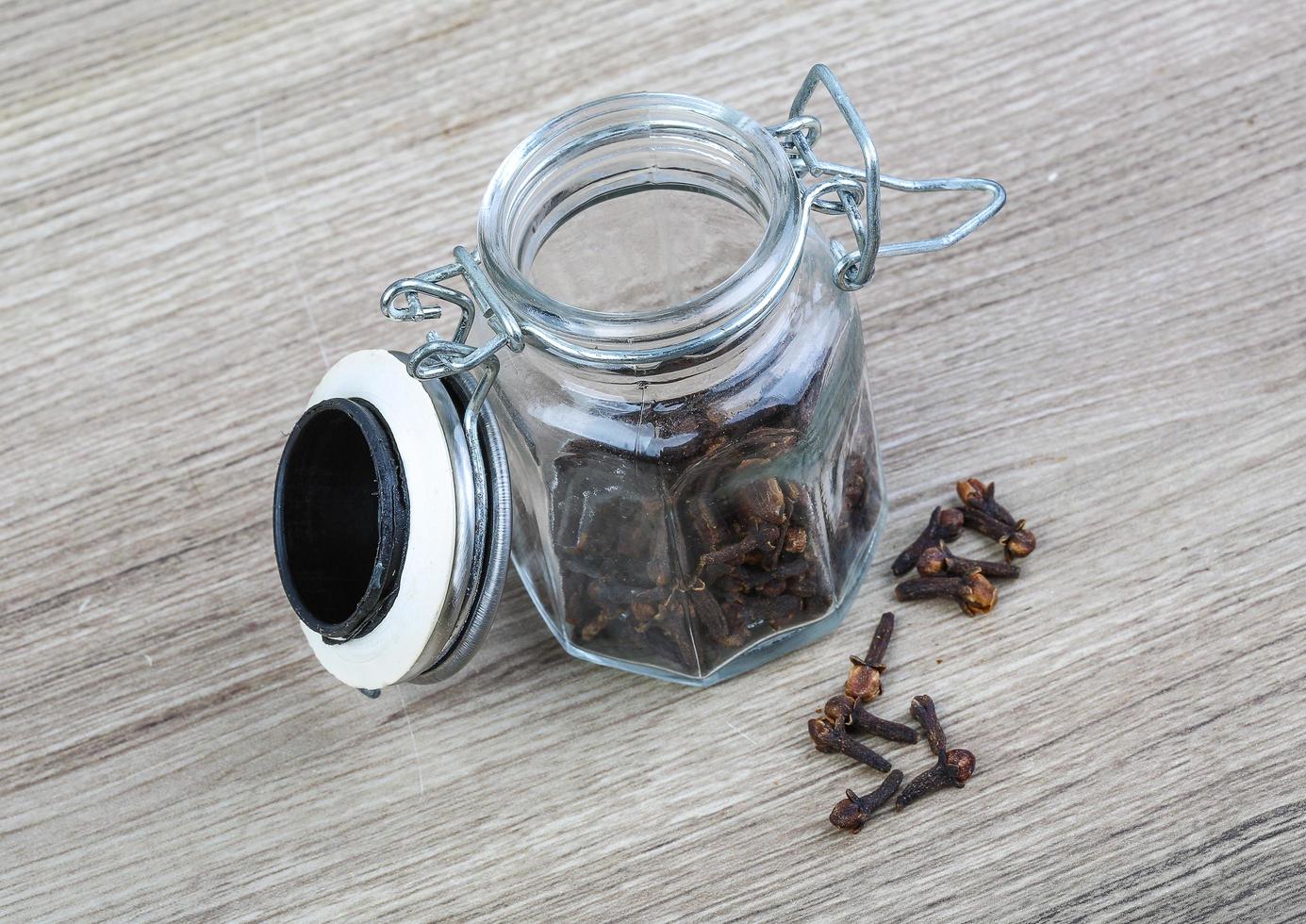 Cloves seeds on wooden background photo