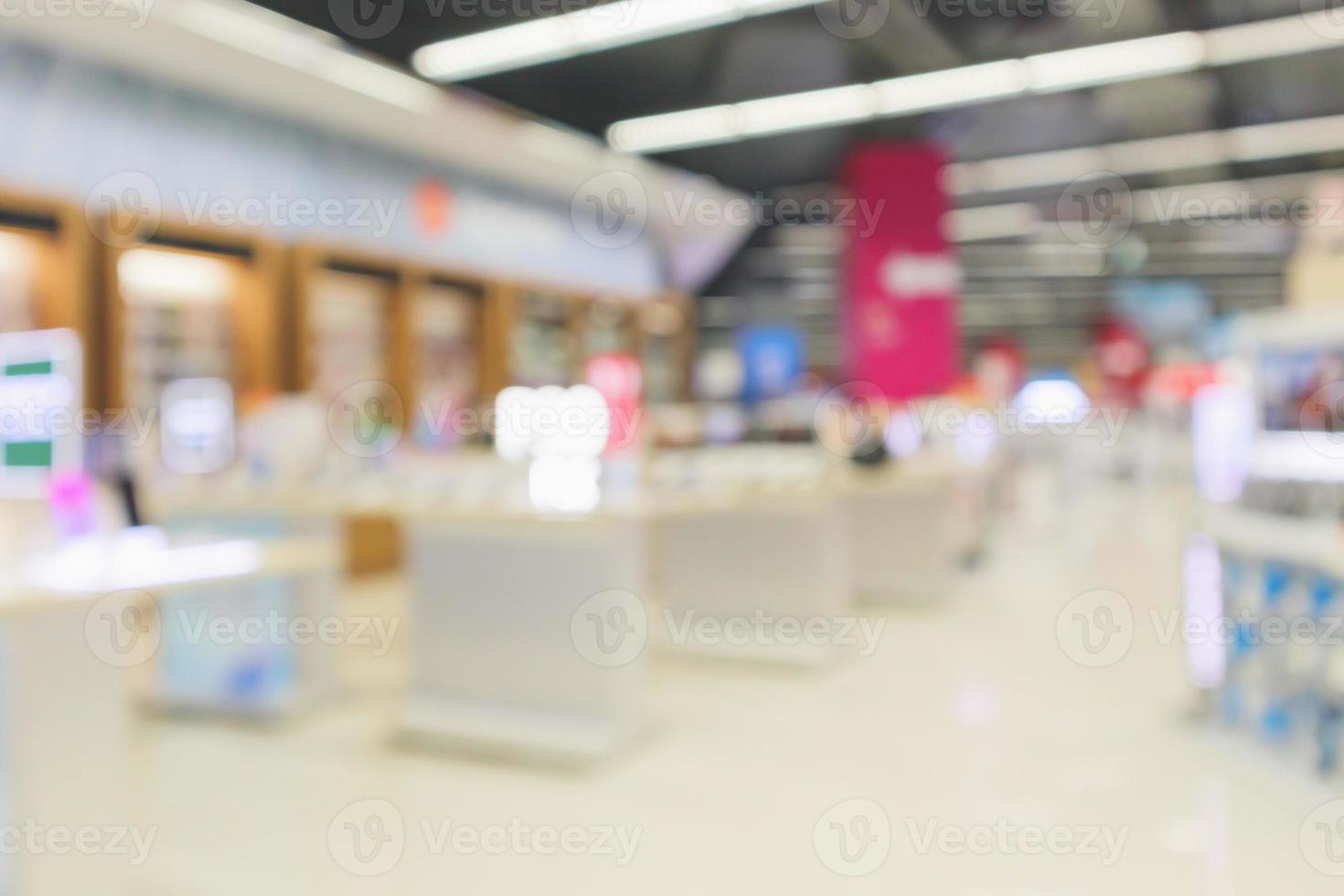 mobile phone in electronic store interior with customer abstract blurred background photo