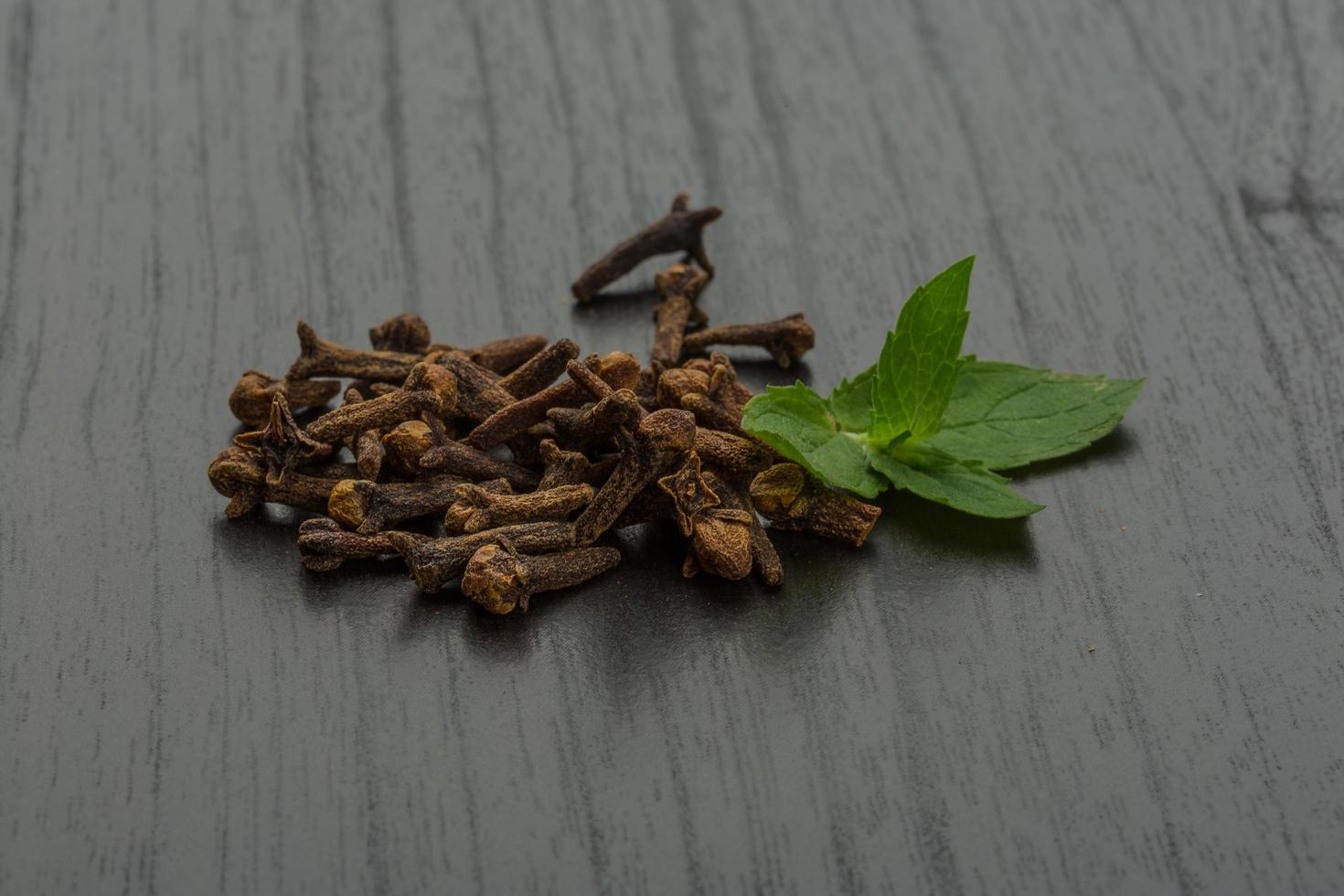 Clove seeds on wooden background photo