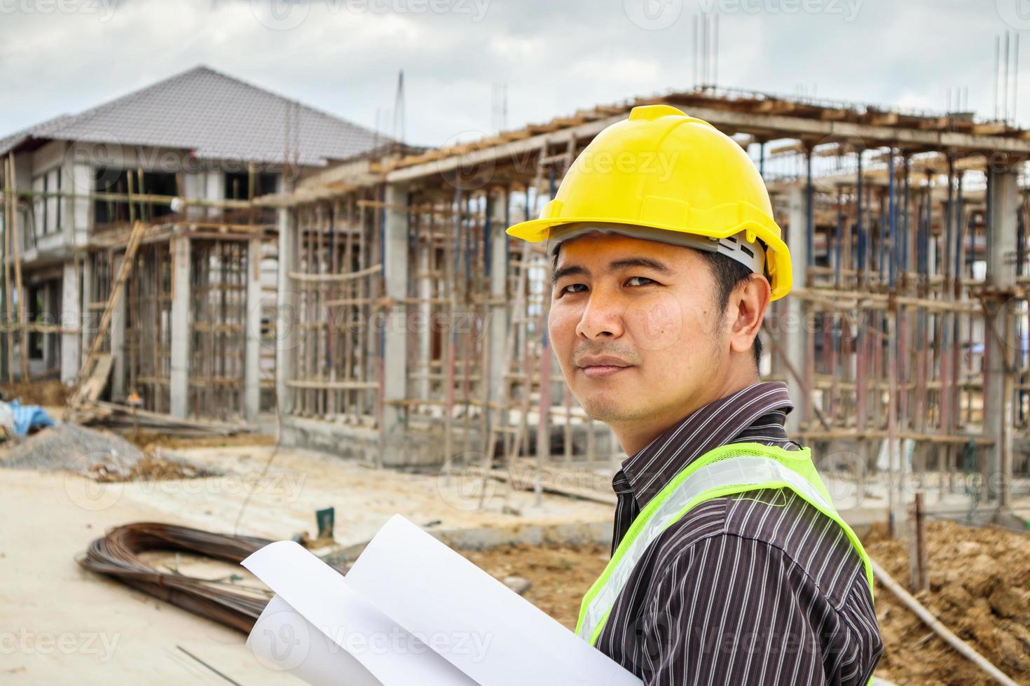 Asian business man construction engineer worker at house building site photo