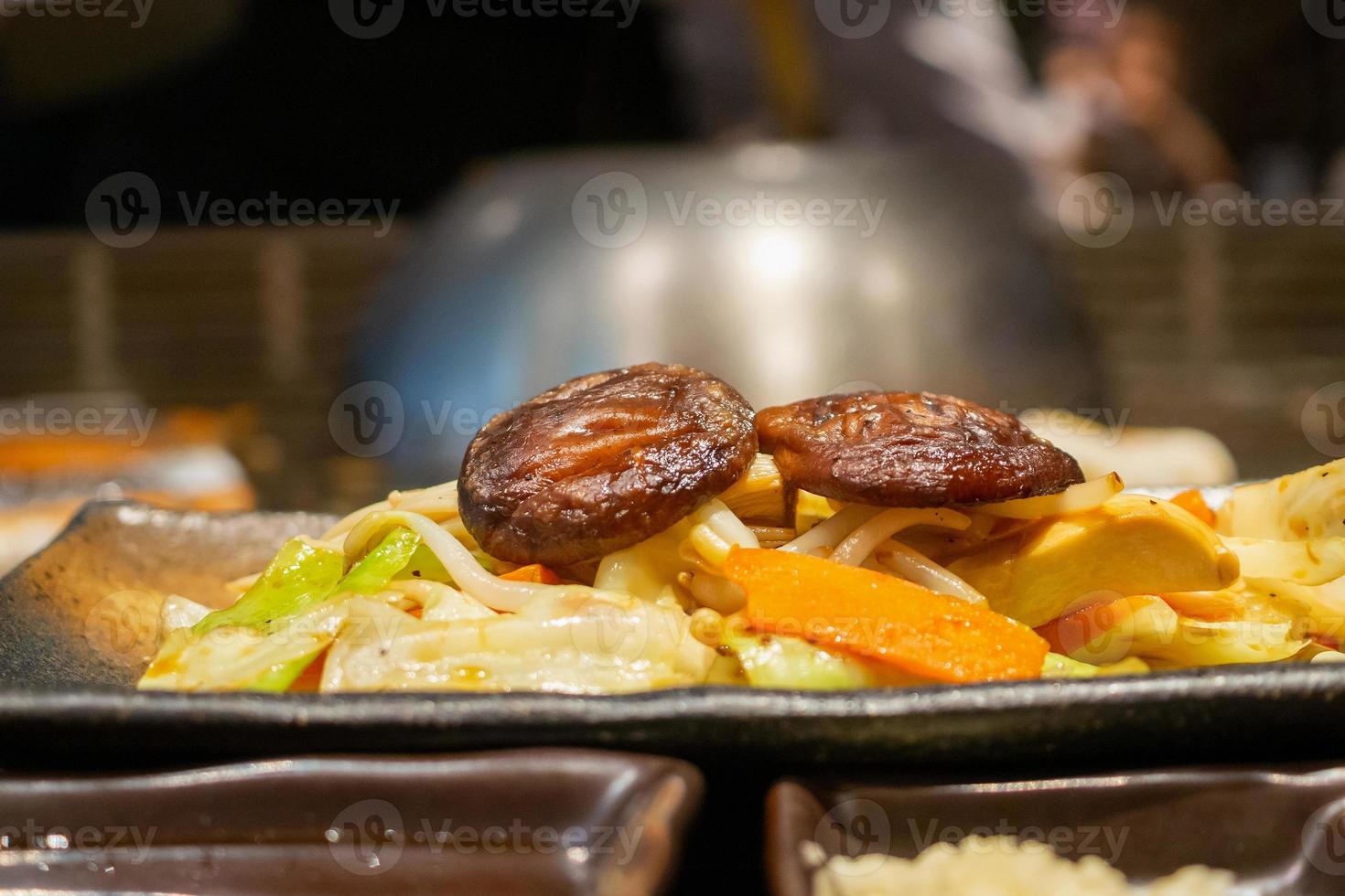 Stir fried Shiitake mushroom with vegetable dish in teppanyaki restaurant photo