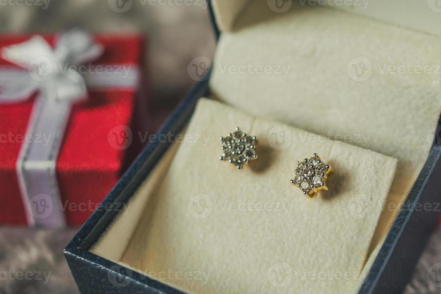 Jewelry gold diamond earring with gift box background photo
