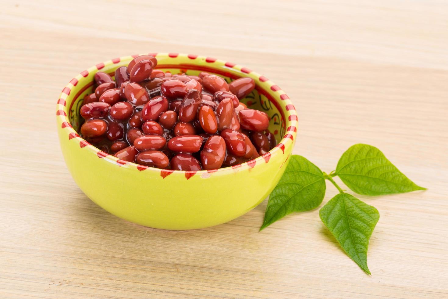 Red beans in a bowl on wooden background photo