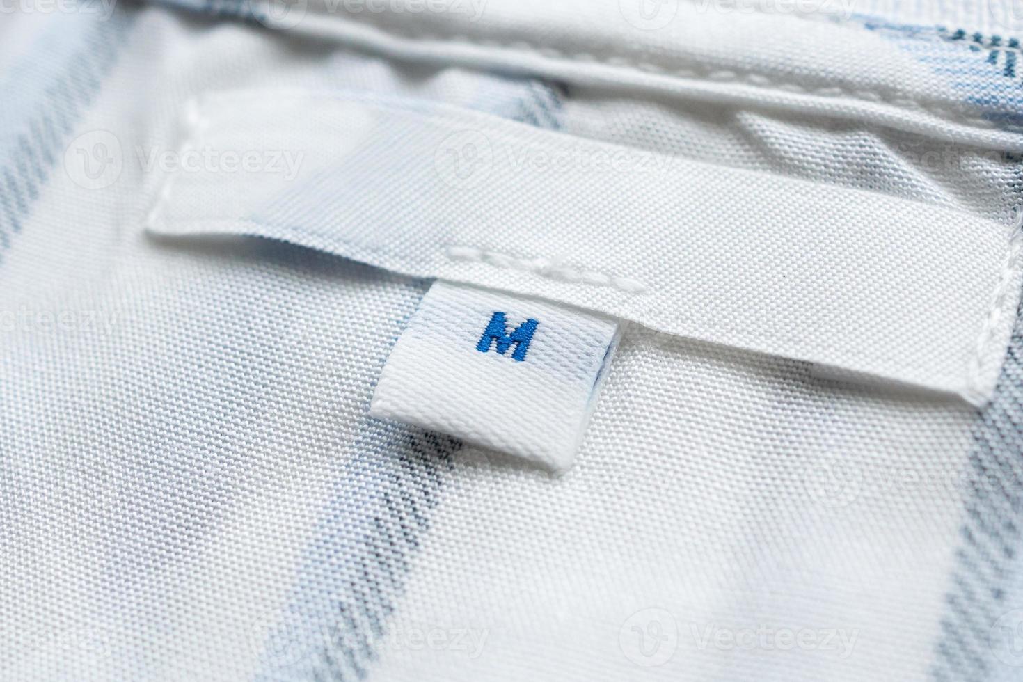 Blank white clothes label on new shirt photo