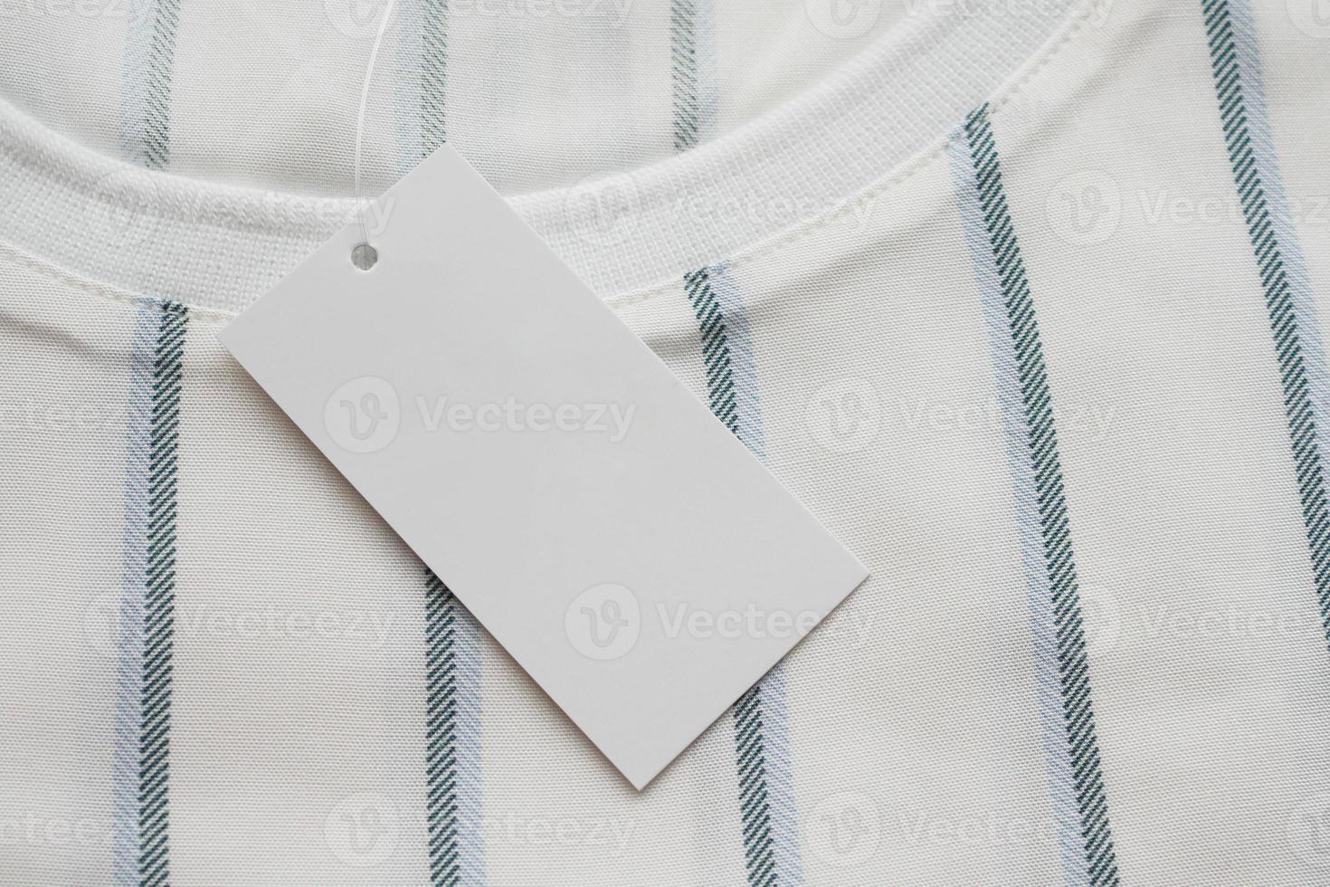 Blank white clothes tag label on new shirt photo