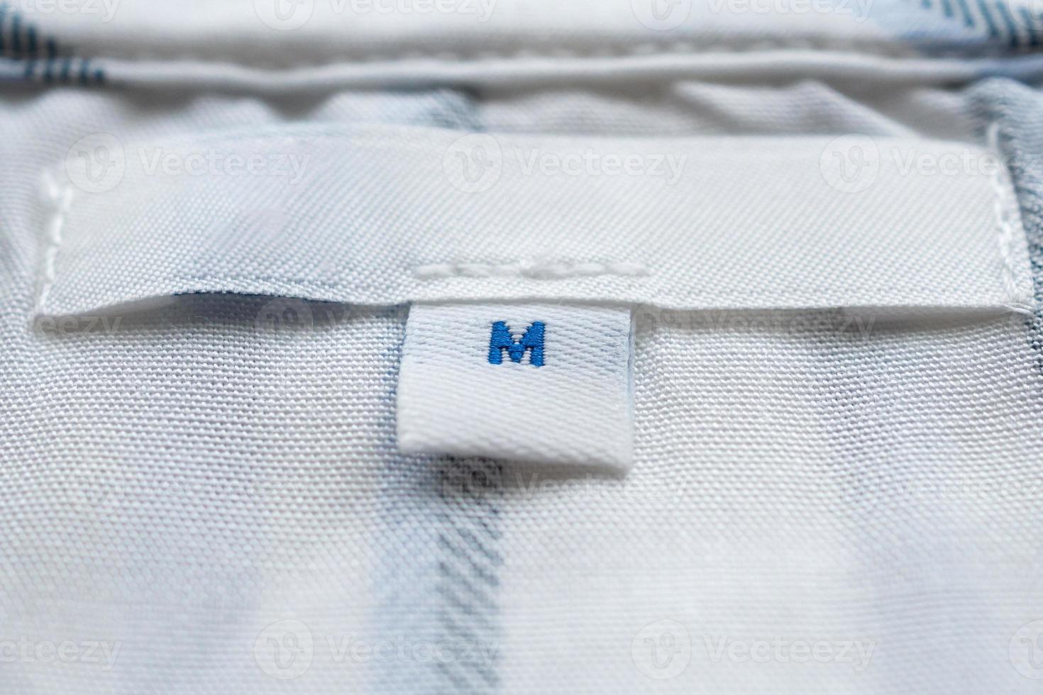 White clothes label close up on new shirt photo
