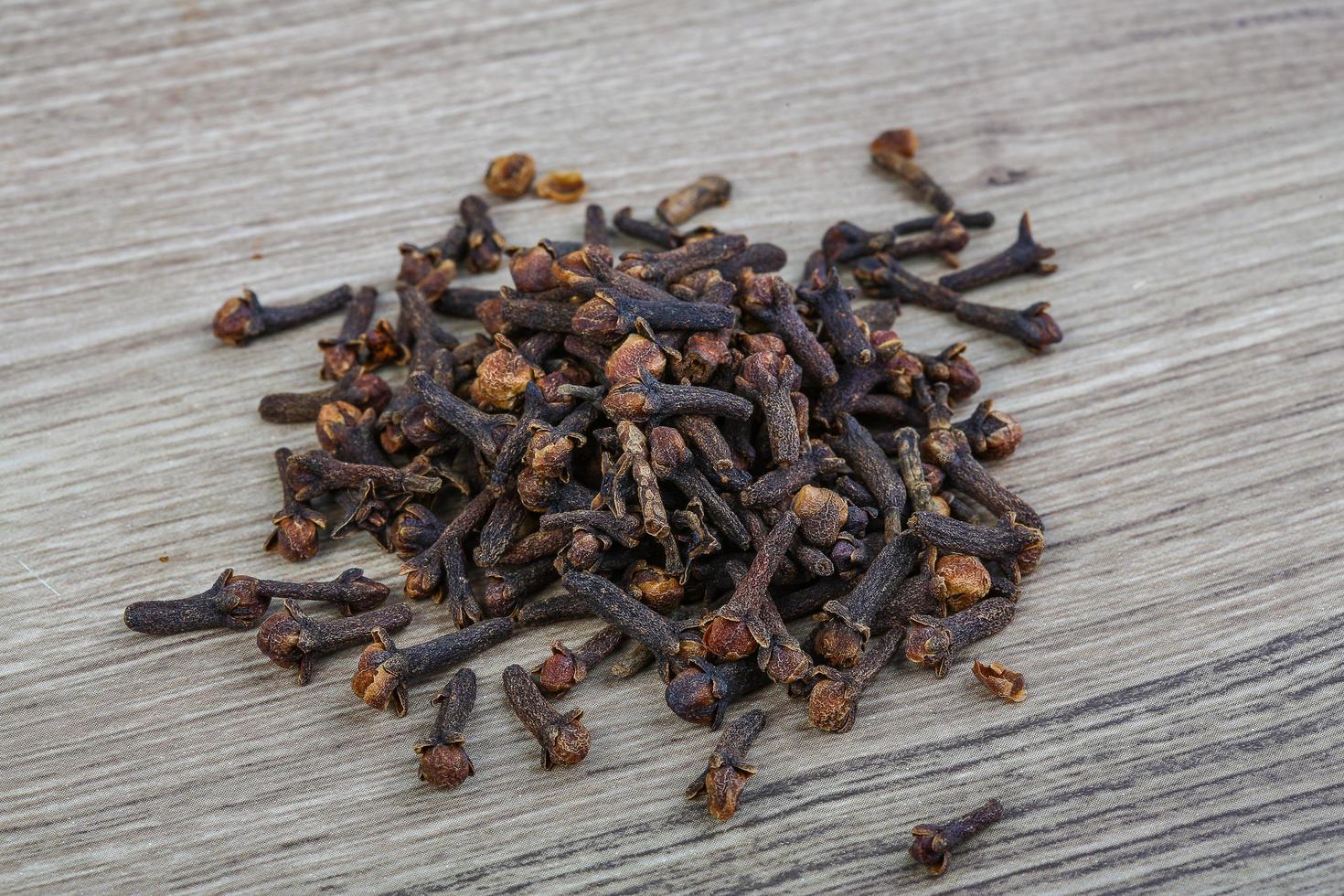 Cloves seeds on wooden background photo
