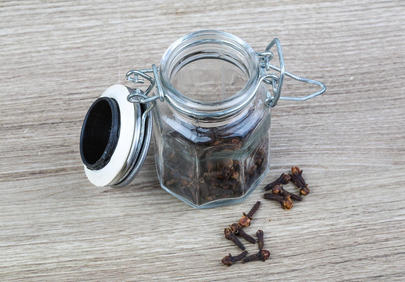 Cloves seeds on wooden background photo