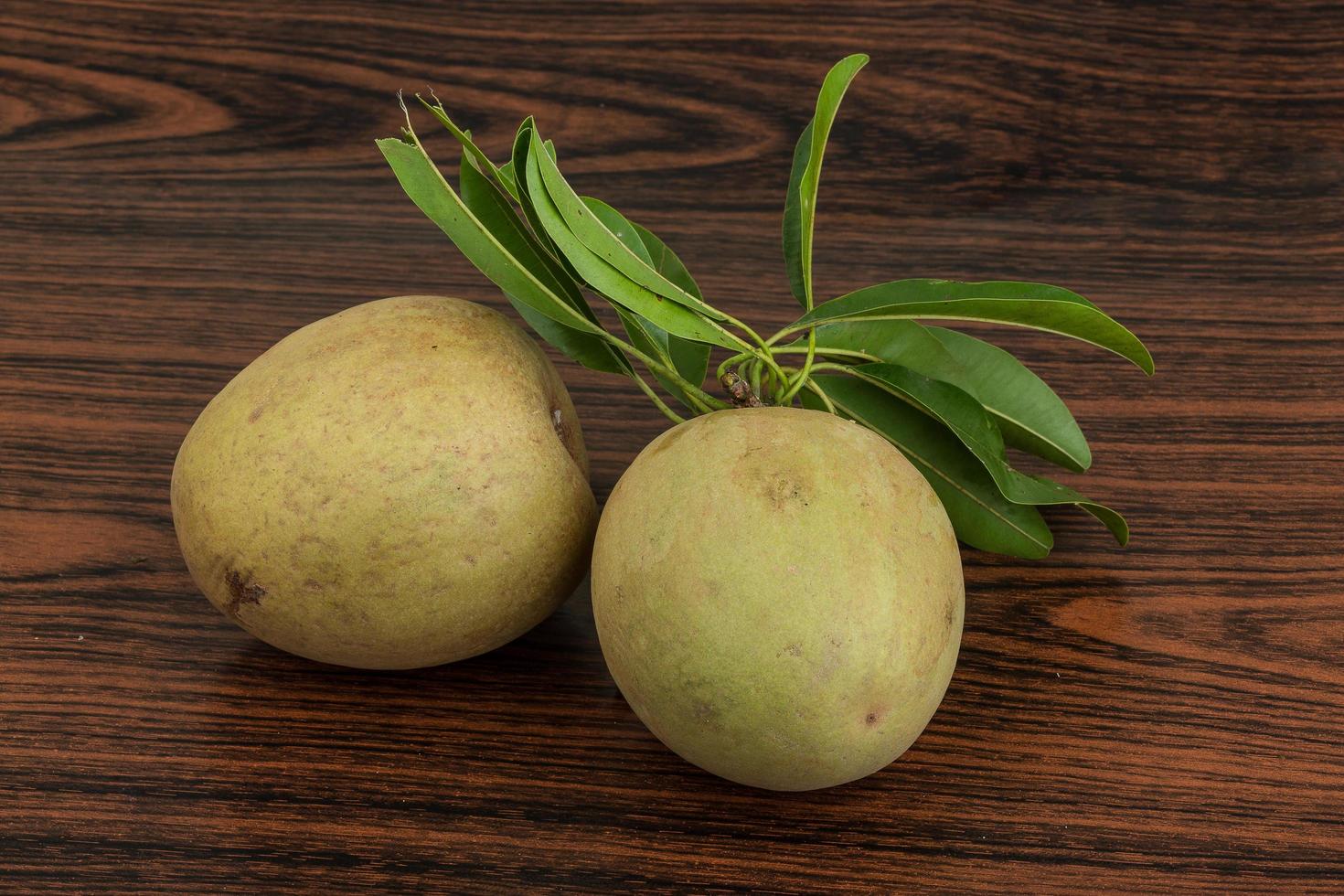 Sapodilla on wooden background photo