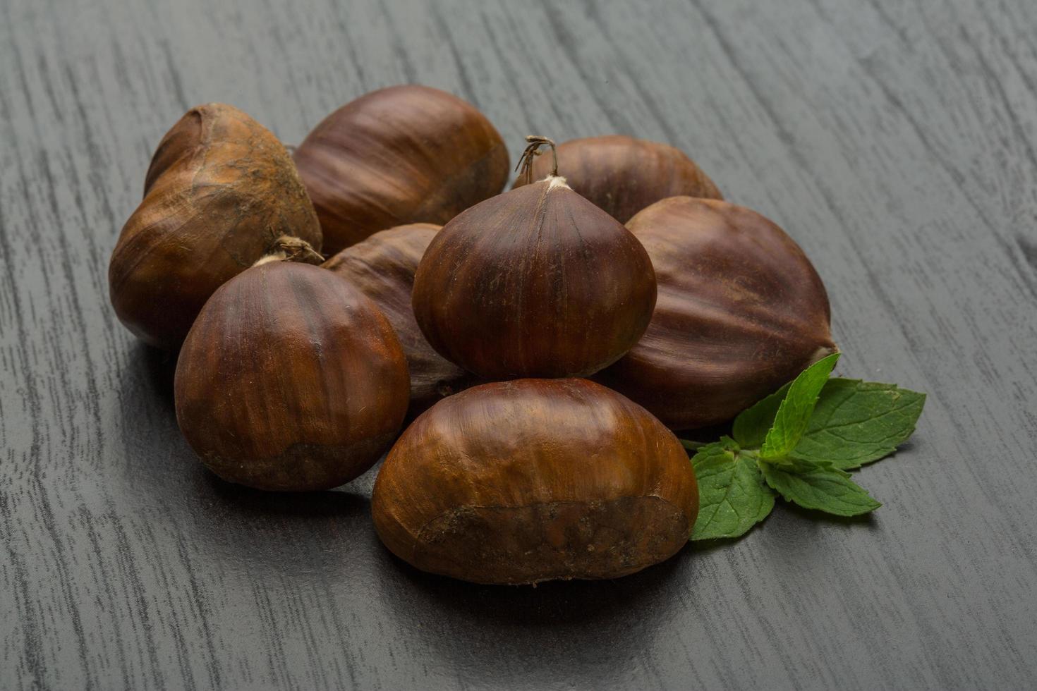 Chestnut on wooden background photo