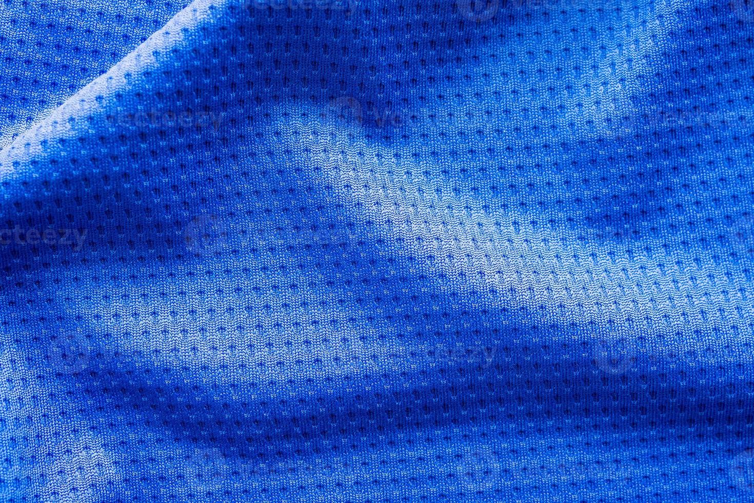 Blue color fabric sport clothing football jersey with air mesh texture background photo