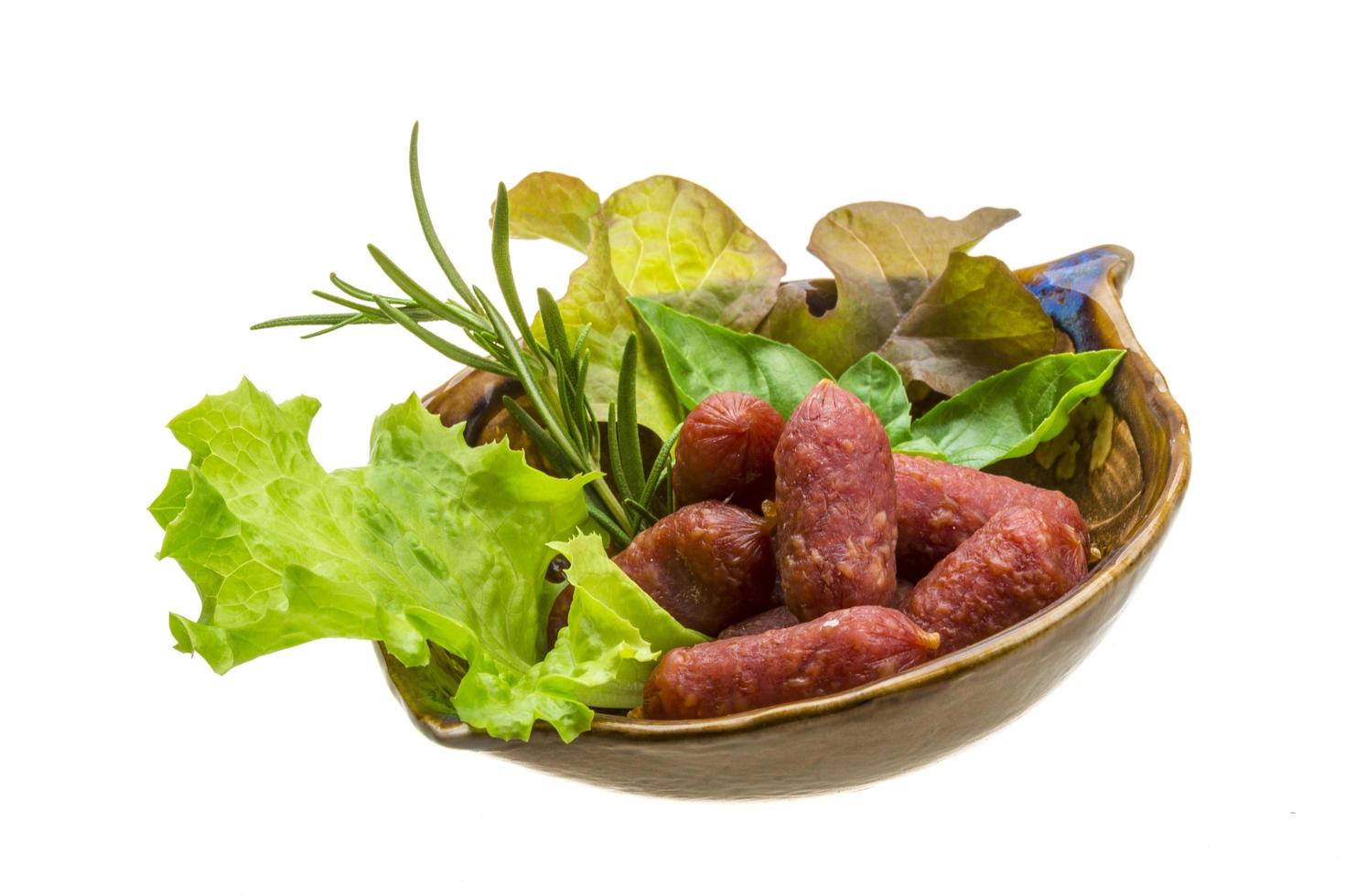 Salami sausages in a bowl on white background photo