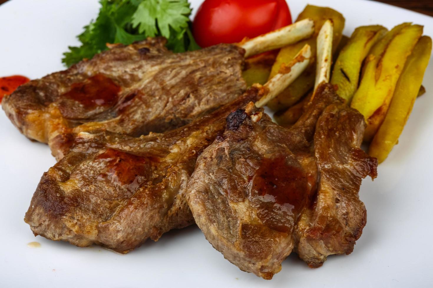 Lamb chops on the plate close up view photo