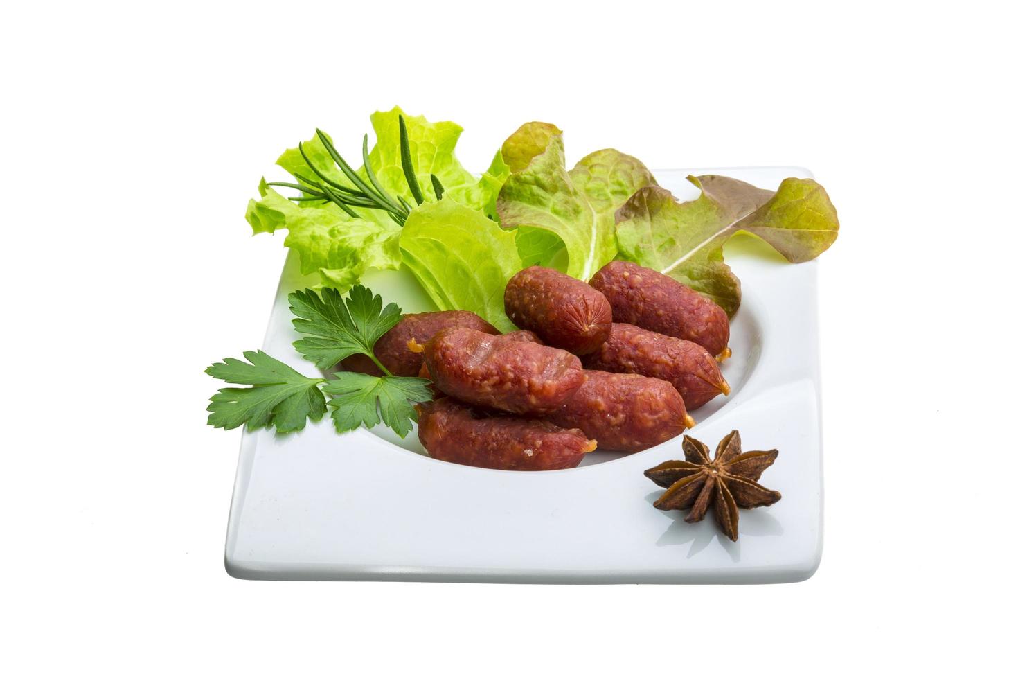 Salami sausages in a bowl on white background photo