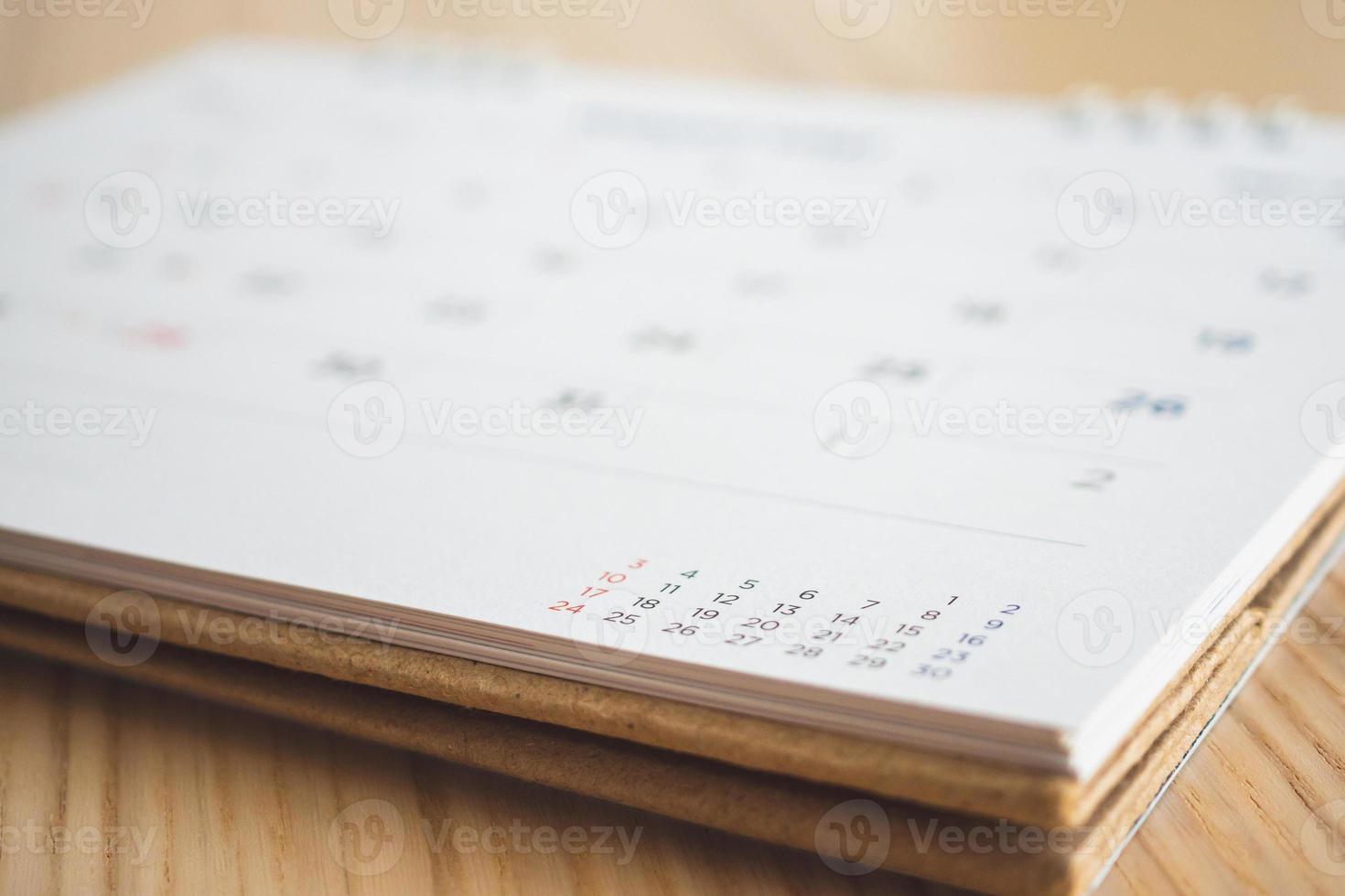 calendar page on wood table background photo