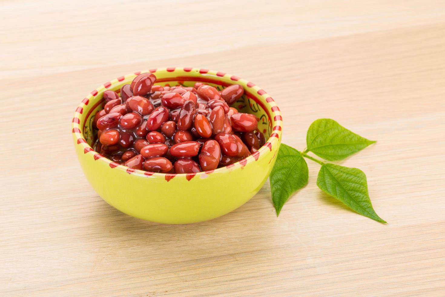 Red beans in a bowl on wooden background photo